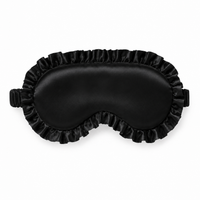 A black satin personalised sleep mask with a ruffled edge and elastic strap, shown flat against a white background.