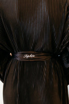 A close-up of a black pleated dress ing gown with a matching pleated belt featuring the name 'Sophia' embroidered in white script.