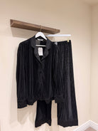 pair of black pyjamas  hanging up