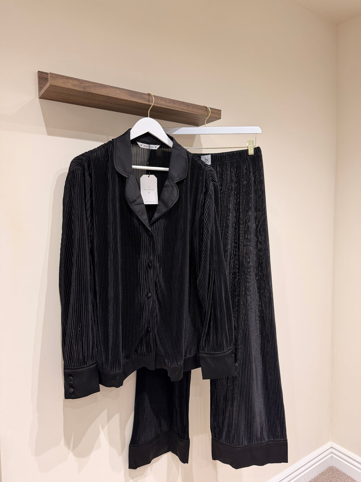 pair of black pyjamas  hanging up